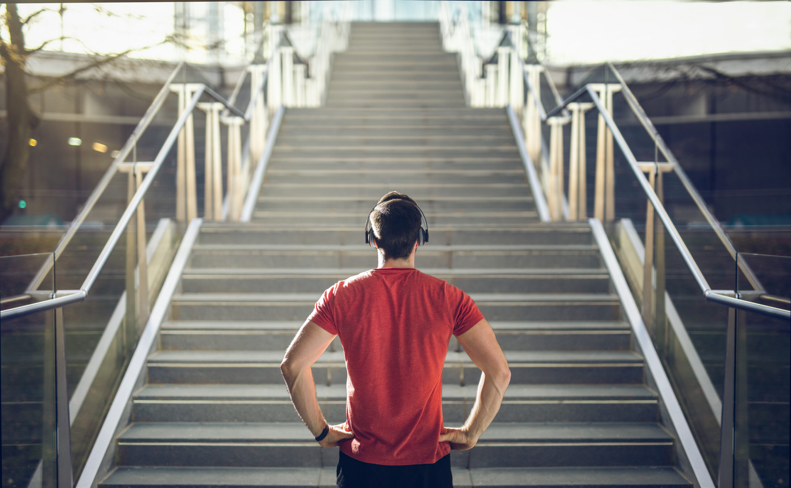 A man looking at the stairs and trying to climb